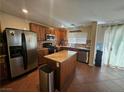 Traditional kitchen features a center island, stainless steel appliances, and tiled flooring at 4256 Perfect Drift St, Las Vegas, NV 89129