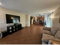 Open-concept living room with tile floors flows into a kitchen at 4256 Perfect Drift St, Las Vegas, NV 89129
