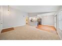 Spacious living room featuring carpet, hardwood floors, and views to the kitchen at 5060 Jeffreys St # 201, Las Vegas, NV 89119