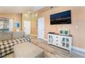 Open-concept living area with a modern media console, wood-look flooring, and neutral colors at 5532 Sentinel Bridge St, Las Vegas, NV 89130