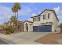 Inviting two-story home with palm trees, desert landscape and a two-car garage at 6407 Wild Strawberry Ln, Las Vegas, NV 89142