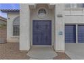 Close-up of front door with decorative gate and stucco exterior, with house number at 6407 Wild Strawberry Ln, Las Vegas, NV 89142