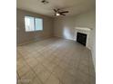Spacious living room featuring tile flooring, a ceiling fan, and fireplace at 6749 Charleston Blvd # 3, Las Vegas, NV 89146