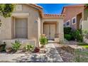 Inviting front entrance with double doors, manicured landscaping, and a charming walkway leading to the home at 708 Canterbury Cross Pl, Las Vegas, NV 89144