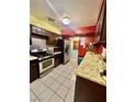 Functional kitchen features stainless steel appliances, tile floors, and tile countertops at 7200 Alta Dr, Las Vegas, NV 89145