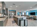 Open kitchen with granite countertops, stainless steel appliances, and an island at 7821 Mazarine St, North Las Vegas, NV 89084