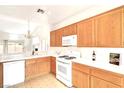 Bright and airy kitchen featuring white countertops, wood cabinets, and a view into the adjacent room at 8120 Backpacker Ct, Las Vegas, NV 89131