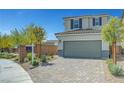 Charming two-story home featuring a paved driveway and a two-car garage at 8349 Pollenzo Ave, Las Vegas, NV 89178