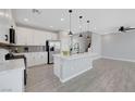 Bright kitchen with white cabinets, a kitchen island, and stainless steel appliances at 8349 Pollenzo Ave, Las Vegas, NV 89178