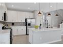 Modern kitchen featuring white cabinets, stainless steel appliances, and a kitchen island at 8349 Pollenzo Ave, Las Vegas, NV 89178