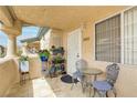 Inviting front patio with seating and plants, offering a cozy outdoor space and an address number 2082 at 8410 Eldora Ave # 2082, Las Vegas, NV 89117