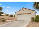 Single-story home showing a two-car garage, desert landscaping, and a neutral color scheme at 884 Adobe Flat Dr, Henderson, NV 89011