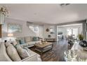 Inviting living room featuring stylish wood floors, neutral paint, comfortable seating, and an open floor plan at 900 Harbor Ave, Henderson, NV 89002