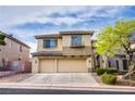 Attractive two-story home featuring a balcony, complemented by a two-car garage and manicured landscaping at 9052 Pine Mission Ave, Las Vegas, NV 89143