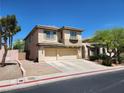 View of a two-story home with desert landscaping, including a two-car garage at 9052 Pine Mission Ave, Las Vegas, NV 89143