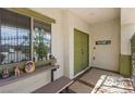 Inviting covered front porch with a seating area, decorative details, and a welcoming double-door entrance at 916 Bob Barney Ct, North Las Vegas, NV 89086