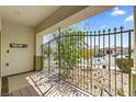 View from the front porch showcasing iron security gate, tile flooring and welcome decor at 916 Bob Barney Ct, North Las Vegas, NV 89086