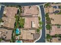 An aerial view of homes featuring red tiled roofs, green lawns, and mature landscaping at 2805 Proust Ct, Henderson, NV 89044