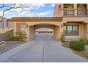 Covered carport area between house and garage, featuring stone accents and a tile roof at 2805 Proust Ct, Henderson, NV 89044