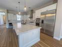 Bright kitchen with large island, stainless appliances, and modern pendant lighting at 2805 Proust Ct, Henderson, NV 89044