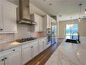 Stylish kitchen featuring stainless steel appliances, large island, and subway tile backsplash at 2805 Proust Ct, Henderson, NV 89044
