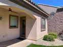 Outdoor patio with stucco walls, exterior door, and manicured landscaping offering private relaxation at 2805 Proust Ct, Henderson, NV 89044