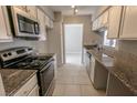 Efficient kitchen features granite countertops, sleek white cabinets, and modern stainless steel appliances at 2866 Loveland Dr # 2017, Las Vegas, NV 89109