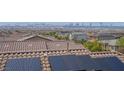 Rooftop view showcasing city skyline, solar panels, and beautiful tile roof at 301 Resolute Ave, Henderson, NV 89011