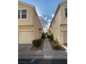 Exterior view of townhouse with sidewalk leading to rear units at 4675 Color Up Ct # 101, Las Vegas, NV 89122