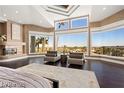 Bright, open main bedroom with fireplace and city views through expansive windows at 5020 Spanish Heights Dr, Las Vegas, NV 89148