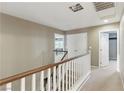 Upstairs hallway with carpet, white doors, and natural lighting at 5144 Poem Ct, North Las Vegas, NV 89081
