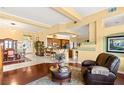 Open-concept living room and dining area with hardwood floors, ample natural light, and stylish furnishings at 5940 Vizzi Ct, Las Vegas, NV 89131