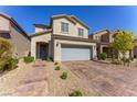 Inviting two-story home with a stone driveway and walkway leading to a welcoming front porch at 9010 Eagle Wall Ct, Las Vegas, NV 89178