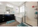 Bathroom features a walk-in shower, soaking tub, and dual vanities at 10126 Cliff Dwellings Ave, Las Vegas, NV 89178