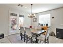 Bright dining room with stylish chandelier and access to the backyard at 10126 Cliff Dwellings Ave, Las Vegas, NV 89178