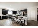 Modern kitchen with dark cabinetry, stainless steel appliances, and a large center island at 10126 Cliff Dwellings Ave, Las Vegas, NV 89178