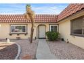Welcoming front entrance with a charming white door, decorative windows and desert landscaping at 1619 Abby Ave, Henderson, NV 89014