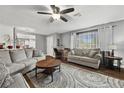 Bright living room with hardwood flooring, neutral-colored walls, a ceiling fan and comfortable seating at 1619 Abby Ave, Henderson, NV 89014