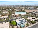 Expansive aerial view of a home with a pool, solar panels, and proximity to the Las Vegas Strip skyline at 2209 Purple Majesty Ct, Las Vegas, NV 89117