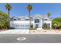 View of the front exterior featuring a three car garage and desert landscaping with palm trees at 2209 Purple Majesty Ct, Las Vegas, NV 89117