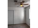 Bedroom features wide closet with sliding doors, and overhead ceiling fan at 3275 Arville St # C, Las Vegas, NV 89102