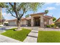 Inviting home with a lush front yard, mature trees, and attractive stone steps leading to the front door at 4176 Skywalker Ave, Las Vegas, NV 89120