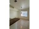 Cozy dining area featuring a large window letting in natural light and tile floors at 4176 Skywalker Ave, Las Vegas, NV 89120