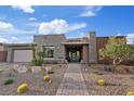 Beautiful single story home with desert landscaping, stone accents, and a brick walkway at 10018 Regency Square Ave, Las Vegas, NV 89148