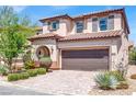 Attractive two-story home boasting a tile roof, desert landscaping, and a large two-car garage at 10976 Bluebell Basin Rd, Las Vegas, NV 89179