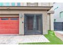 An entrance featuring a red garage door and a metal gate at 11228 Burning River St, Las Vegas, NV 89183