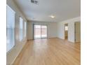 Spacious living room with wood flooring, natural light, and access to the backyard at 11668 Tierney Creek Dr, Las Vegas, NV 89183