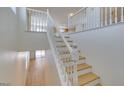 Light and bright staircase with white railings and wood stairs at 11668 Tierney Creek Dr, Las Vegas, NV 89183