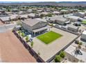 Expansive backyard with desert landscaping, green lawn and large patio at 1512 Sagefield Way, Logandale, NV 89021