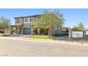 Beautiful two-story home with a well-kept lawn, gated driveway and neighborhood signage at 1512 Sagefield Way, Logandale, NV 89021